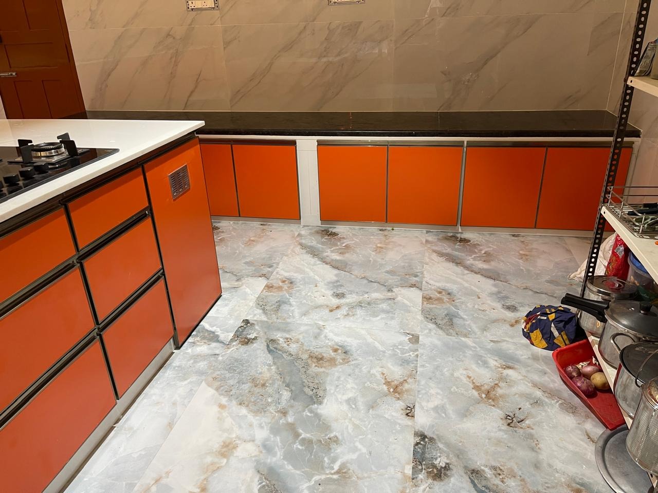 L-shaped Modular Kitchen with Glossy Orange Finish
