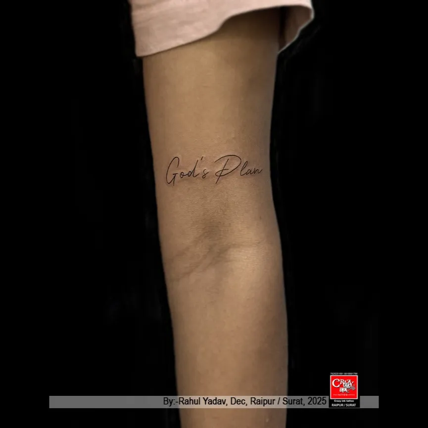 GOD'S PLAN
This minimalist script tattoo featuring the words “God’s Plan” is a beautiful exp...