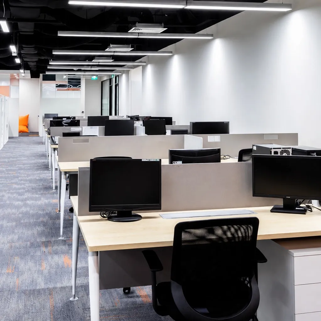 Minimalist Office Workstations with Exposed Ceiling and Linear Lighting