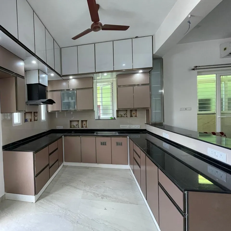 U Shaped Modular Kitchen with Rose Gold Cabinets and Black Granite Countertop