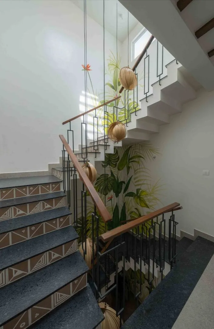 Staircase With Artistic Tiles And Tropical Interior Design