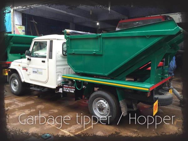 High rise garbage tipper / hopper developed on mini pick-up vehicle. The garbage is collected to door to door with help of this vehicle. The collected garbage is then emptied m into a larger vehicle or a container. The complete system works on hydraulic with control inside the cabin or placed at a convenience of the operator. The drive for the hydraulic is taken from the vehicle's engine and designed as per RTO rules.
