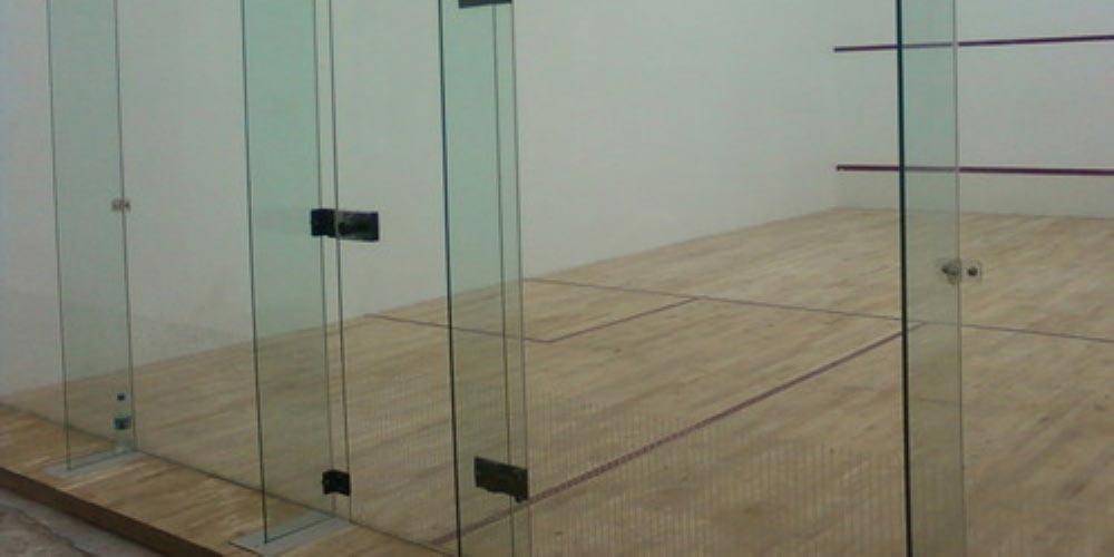 Exhaustively tested by leading competent authorities, the Sundek Glass Wall System meets all recommended safety standards and building codes. The design, manufacture and installation of all components are rigorously controlled and guarantees that repeated high energy impacts can be withstood without breakage whilst still providing an ideal court wall. The unique door hinge completely eliminates the risk of finger being trapped in the door. The glass walls give spectators a clear unimpeded view of the action happening on the court which also helps in coaching and provides a good view for the referee. The material used is wholly compatible with 12 mm toughened glass and able to cope with the constant stresses applied.
Sundek Air Cush Wooden Flooring
Sundek Squash Court Glass Back Wall
Sundek Squash Court Hard Plaster
