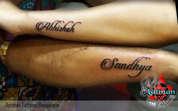 couple tattoo in which we right each other name on their hands couple tattoo in which we right each other name on their hands