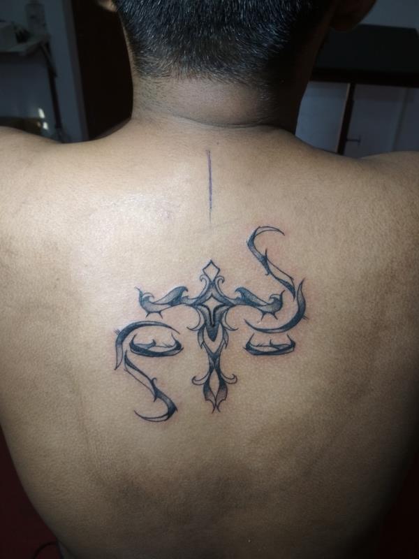 Libra sign tattoo done at back of the Cl