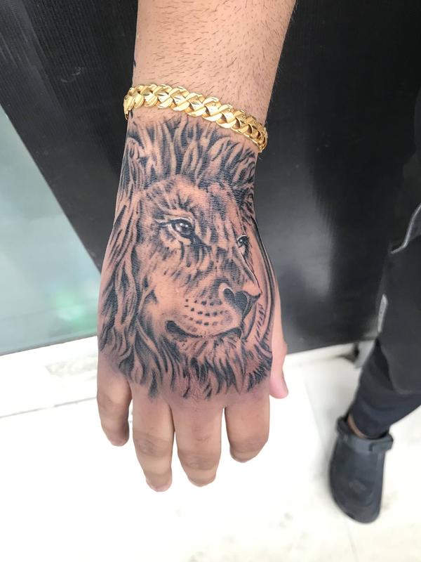 Lion Tattoo done on hand . Realistic lio