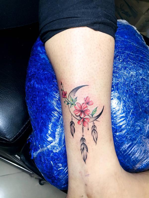 Ankle tattoo with crescent moon and flow