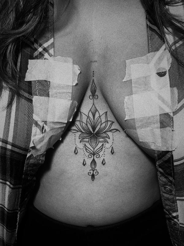 Sternum tattoo design done elegantly at