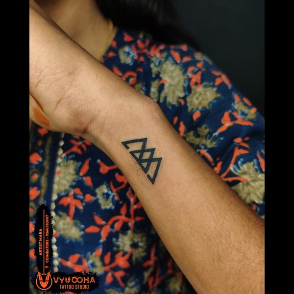 symmetrical geometric tattoo a