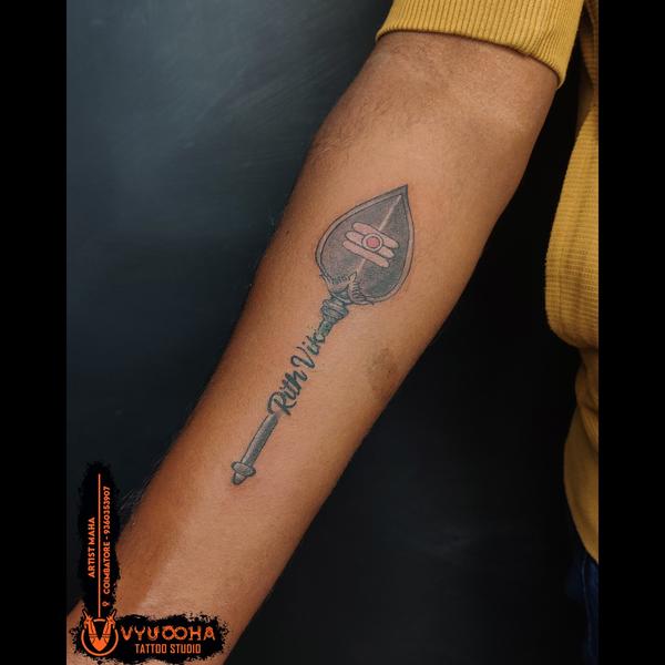 vel tattoo with shiva symbol