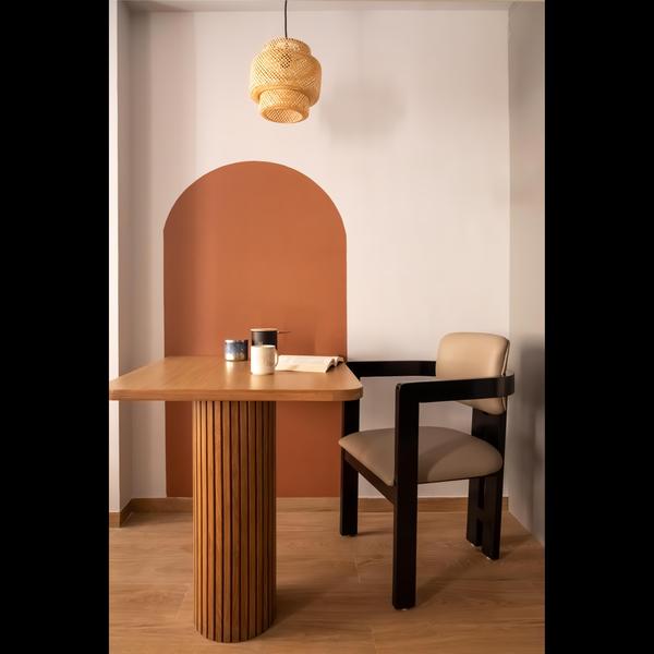 A dining area with a café table by Nitesh Interior