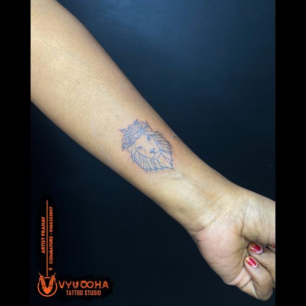 floral lion forearm tattoo coi