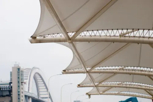 Tensile fabric roofing structu